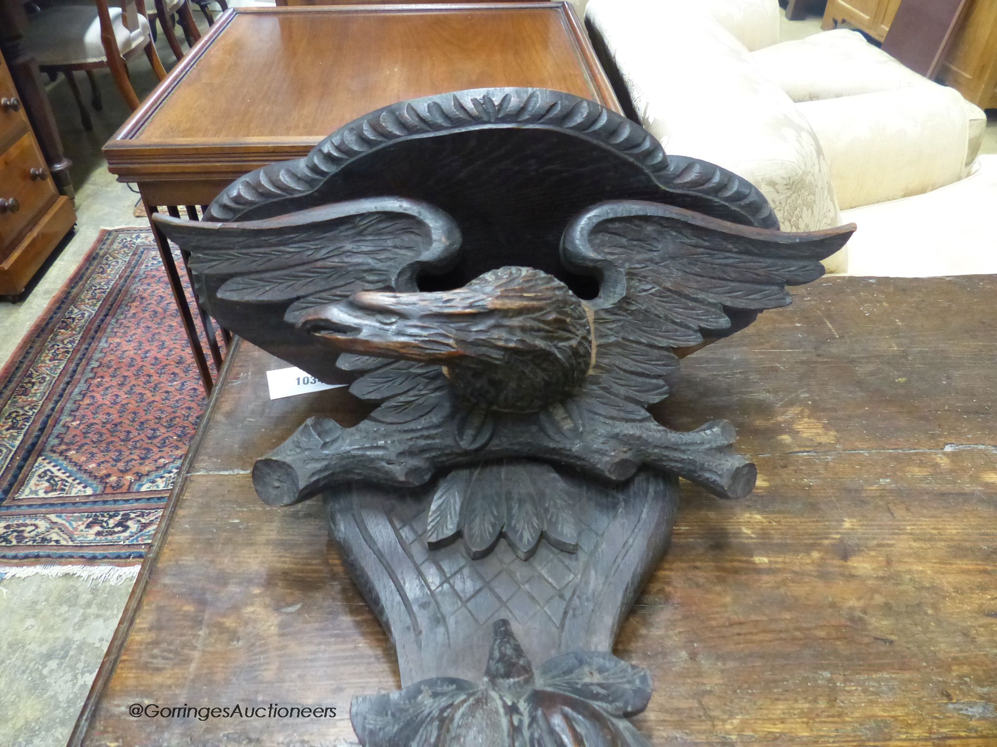 A Black Forest carved oak eagle wall bracket, width 47cm, height 56cm